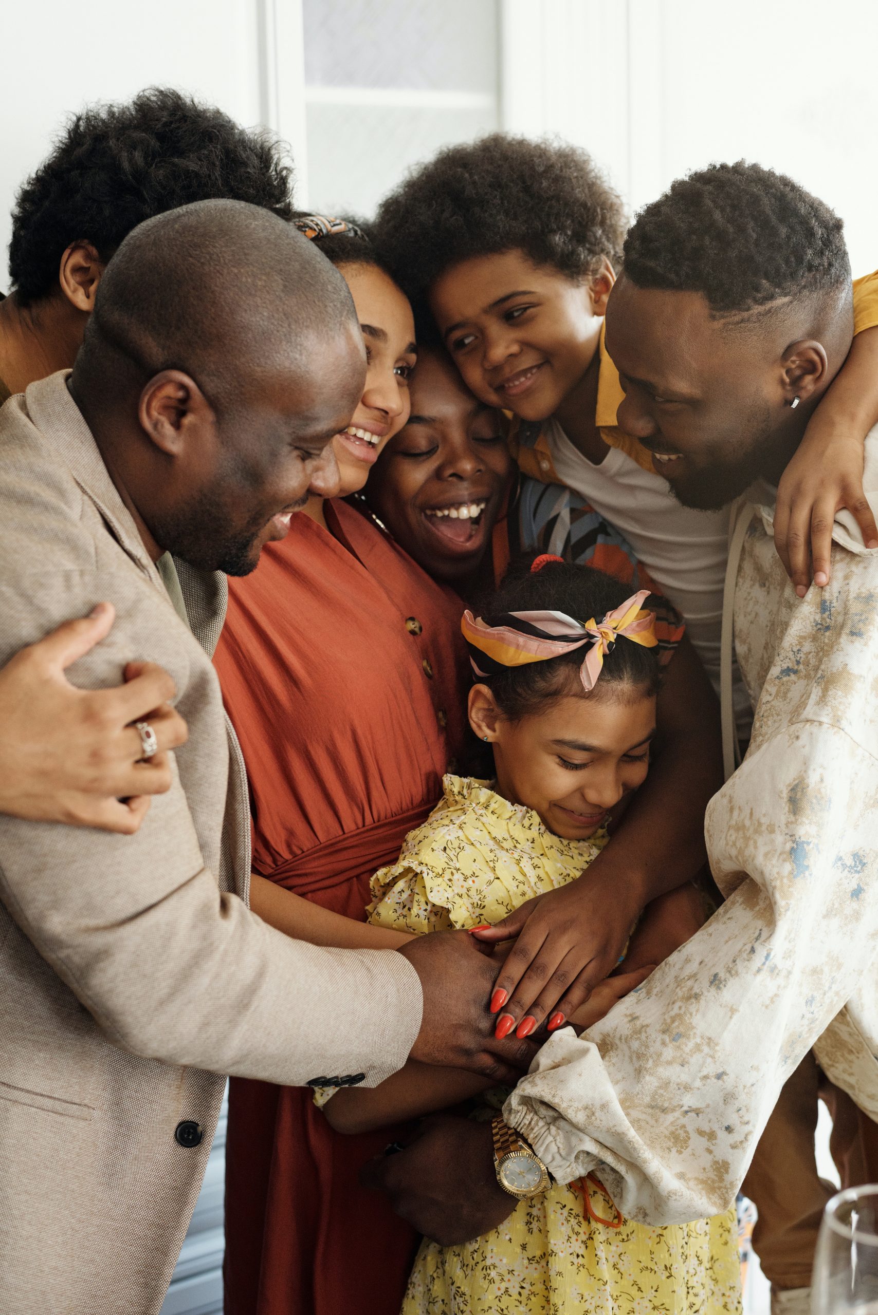 pexels-august-de-richelieu-4262424 a large happy family hugging each other with young daughter in the middle
